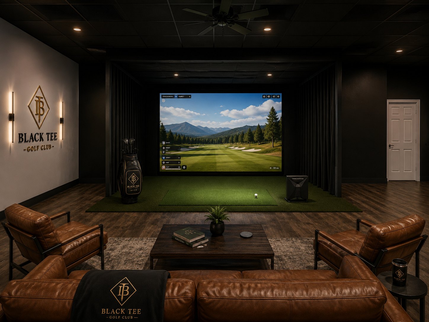 Black Tee private event bay with leather sofa, branded throw and a mountain course on the simulator screen